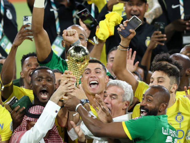 RIYADH, SAUDI ARABIA - AUGUST 12: Cristiano Ronaldo of Al Nassr lifts the Arab Club Champions Cup trophy with teammates after the team's victory in the Arab Club Champions Cup Final between Al Hilal and Al Nassr at King Fahd International Stadium on August 12, 2023 in Riyadh, Saudi Arabia. (Photo by Yasser Bakhsh/Getty Images)
